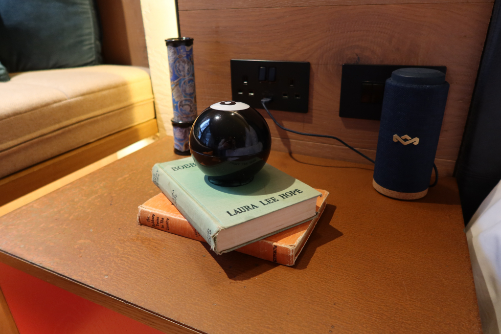 treehouse hotel london studio suite with magic 8 ball, vintage books, speaker and kaleidoscope 