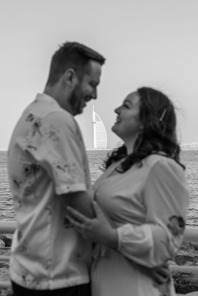Brogan and Benji are out of focus with the Burj Al Arab in the background. The photo is in Black and White.